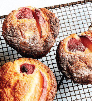 Raspberry and apple muffins, scattered around a wire oven rack.