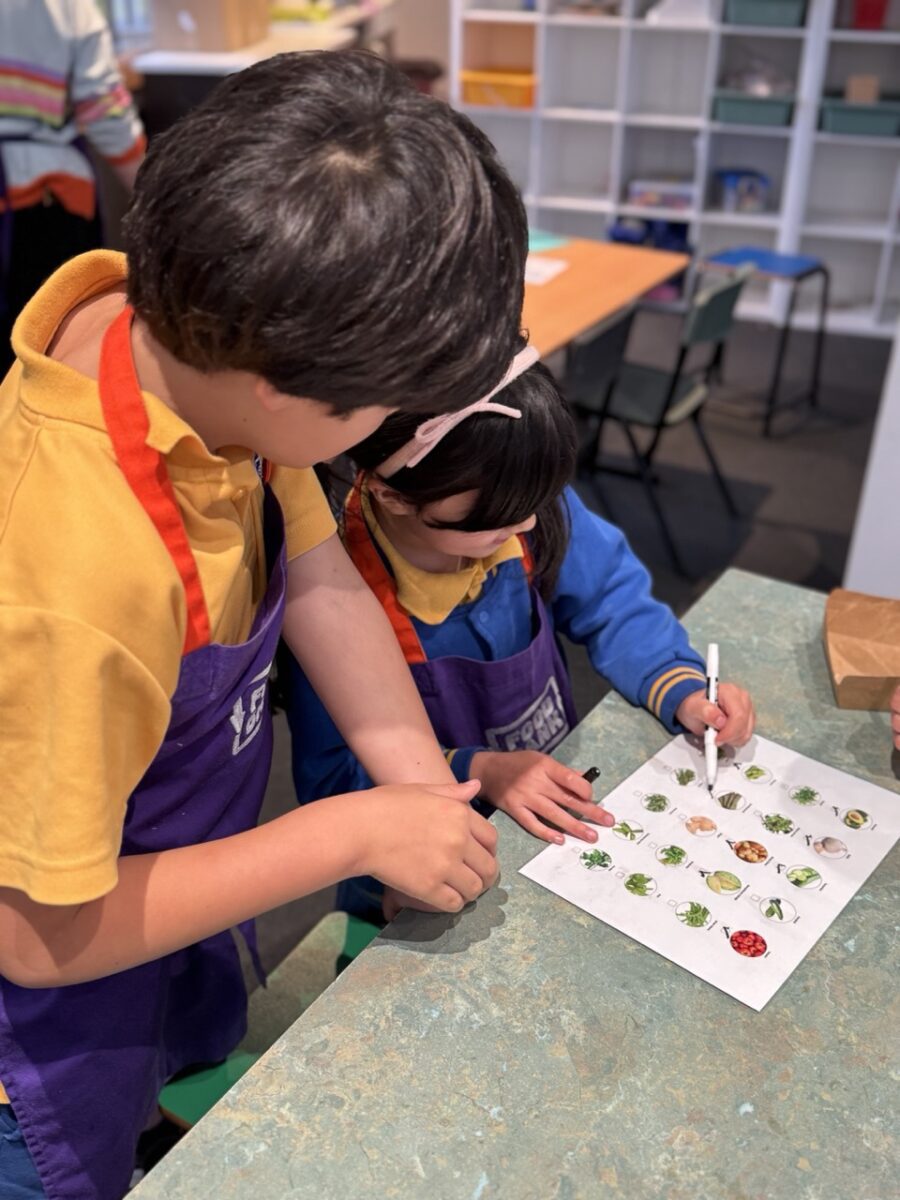 Students looking at veggie handout